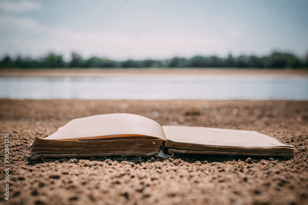 The book is on the beach. Reading on vacation. The book is on the beach. Reading on vacation.