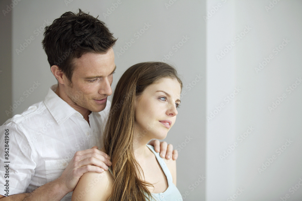 Man touching his girlfriend's shoulders Man touching his girlfriend's shoulders