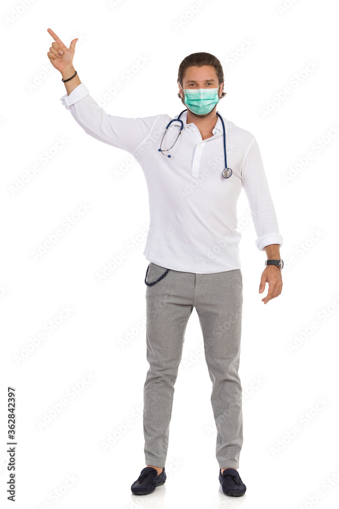 Handsome Male Doctor Is Smiling And Pointing Up Handsome Male Doctor Is Smiling And Pointing Up