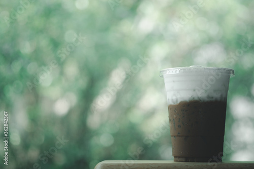 Iced Mocha coffee in takeaway glass and milk foam © Dontree