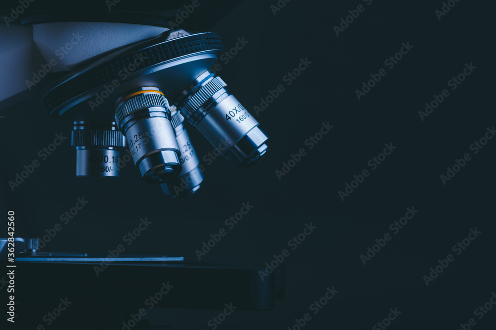 Closeup of Scientific microscope data analysis in the medical science laboratory, black background Closeup of Scientific microscope data analysis in the medical science laboratory, black background