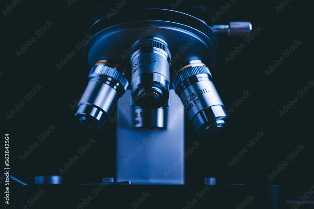 Closeup of Scientific microscope data analysis in the medical science laboratory, black background Closeup of Scientific microscope data analysis in the medical science laboratory, black background