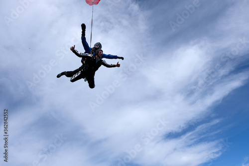 Skydiving. Tandem jump. Two guys are flying in the sky.