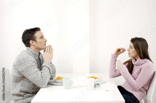 Couple having breakfast cereal