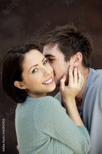 Man kissing his girlfriend © ImageHit
