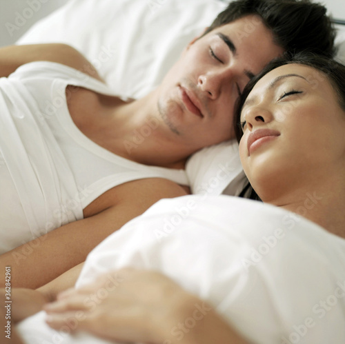 Couple sleeping comfortably on the bed