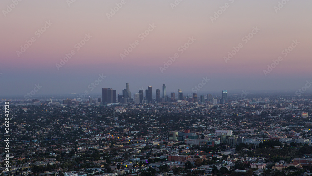 Fototapeta premium The skyline of Los Angele at sunset.