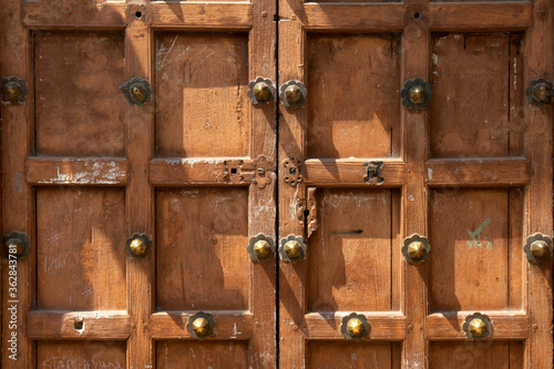 Fotografie Brown simple Swahili door in Zanzibar with brass knobs, ideal for background