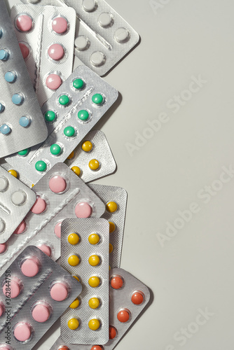 Committed to Care. Cropped shot of flat lay with many medical pills, tablets pack in blister lying randomly over white background. Health care, vitamins and treatment concept