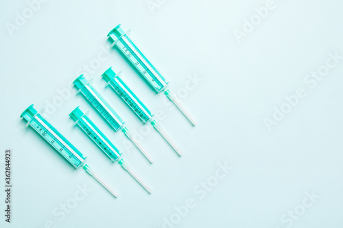 Top view of different syringes for injection on colorful background. Medical equipment concept with copy space