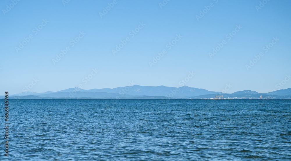 Seascape the background of the clear sky.