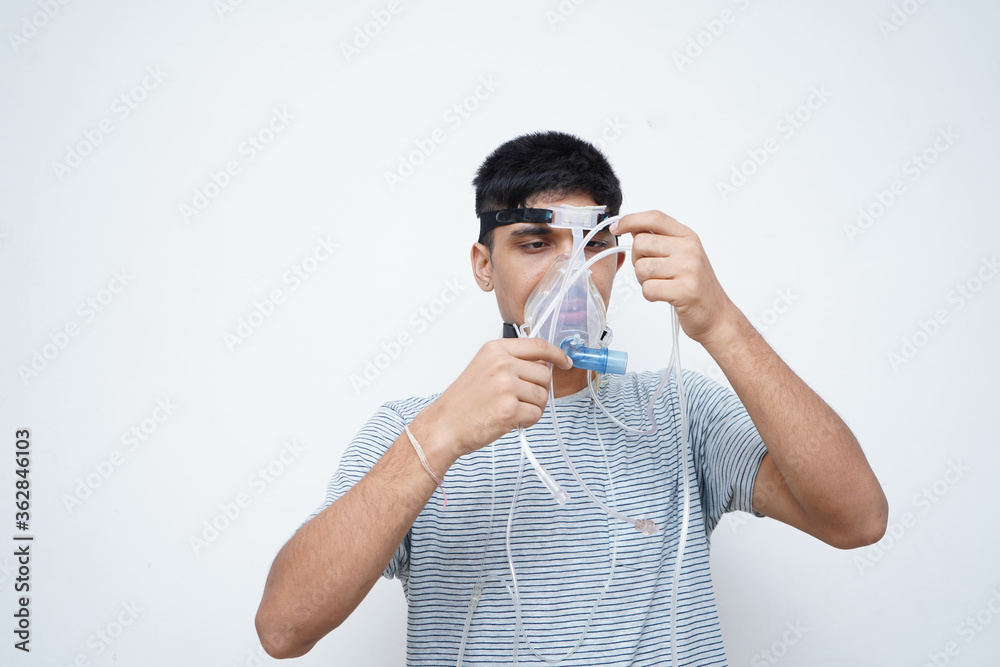 Young handsome asian teen boy wearing an oxygen mask, Stop Corona Virus and Stop pollution concept. Young handsome asian teen boy wearing an oxygen mask, Stop Corona Virus and Stop pollution concept.