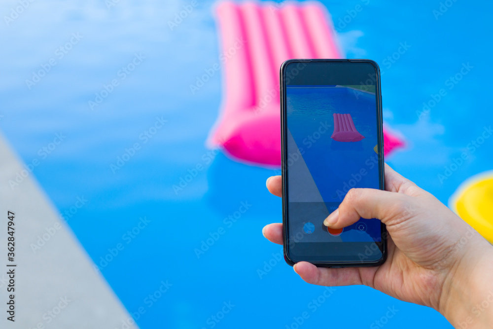 Take photo and video of swimming pool and pink mattress, summertime and empty pool, vacation and holiday, shooting scene.
