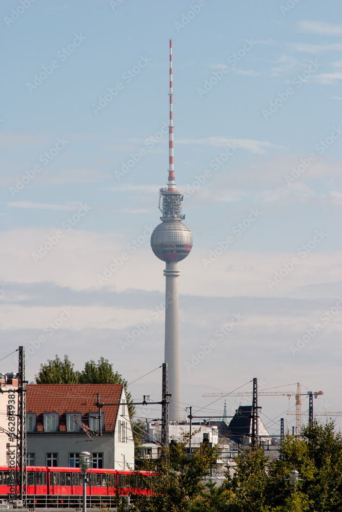 Obraz premium Berlin famous television tower seen in telephoto shot with S-bahn train in foreground
