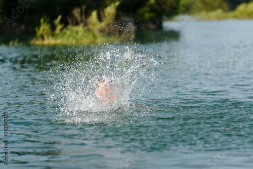 Spray from a floating person in the lake