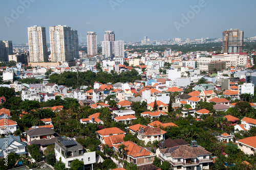 HCMC Vietnam, panorama of local suburb with local houses in foreground and high rise towers in background © KarinD