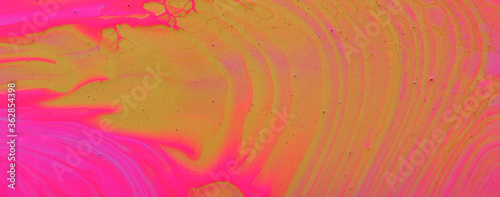 art photography of abstract marbleized effect background. pink and gold creative colors. Beautiful paint.