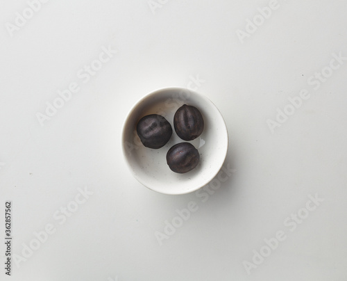 Top view shot of dried lime on white background. loomi, limoo amani, black lime, persian lime