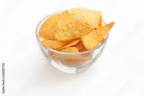 Delicious crispy snacks. Nachos in plate isolated on white background