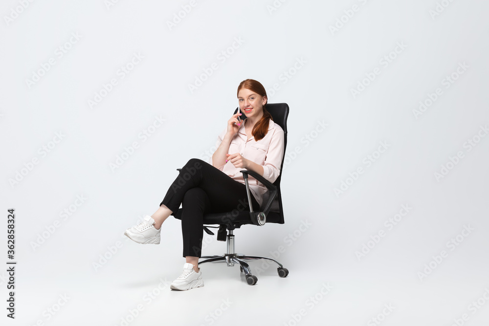 Talking phone. Young woman in casual wear on white background. Bodypositive character, feminism, loving herself, beauty concept. Plus size businesswoman during paperwork. Inclusion, diversity. Talking phone. Young woman in casual wear on white background. Bodypositive character, feminism, loving herself, beauty concept. Plus size businesswoman during paperwork. Inclusion, diversity.