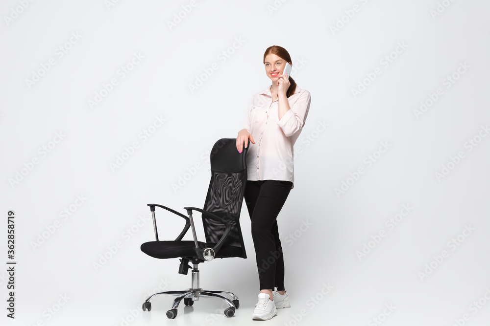 Talking phone. Young woman in casual wear on white background. Bodypositive character, feminism, loving herself, beauty concept. Plus size businesswoman during paperwork. Inclusion, diversity. Talking phone. Young woman in casual wear on white background. Bodypositive character, feminism, loving herself, beauty concept. Plus size businesswoman during paperwork. Inclusion, diversity.