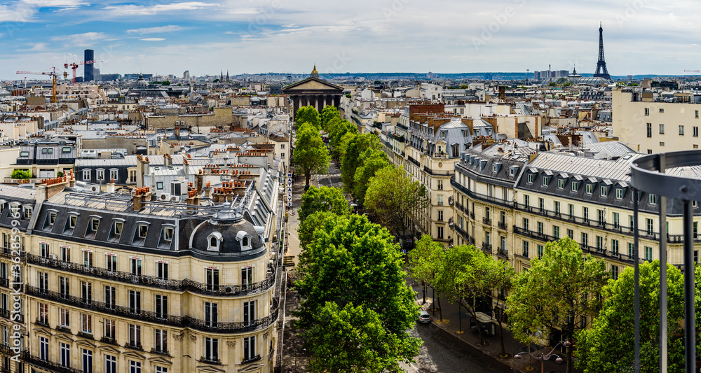 A cityscape of Paris with the Eiffel tower in distance. 