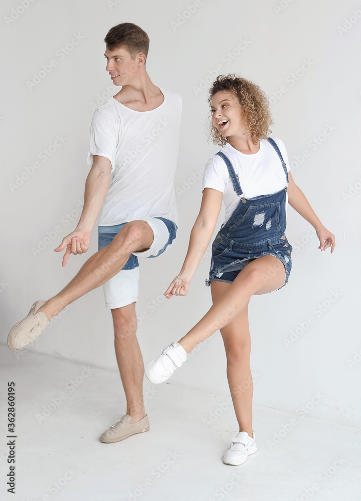 Happy smiling couple dancing in the studio