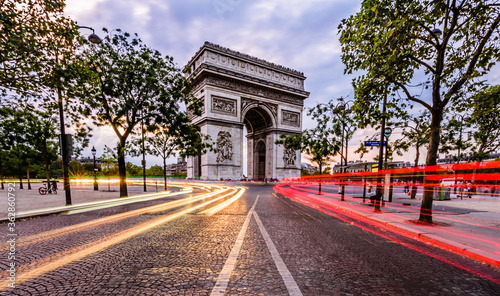 Lightrails of cars in front of The Arc de Triomphe de l'Étoile. It is one of the most famous monuments in Paris, France, standing at the western end of the Champs-Élysées. © Ondrej Bucek