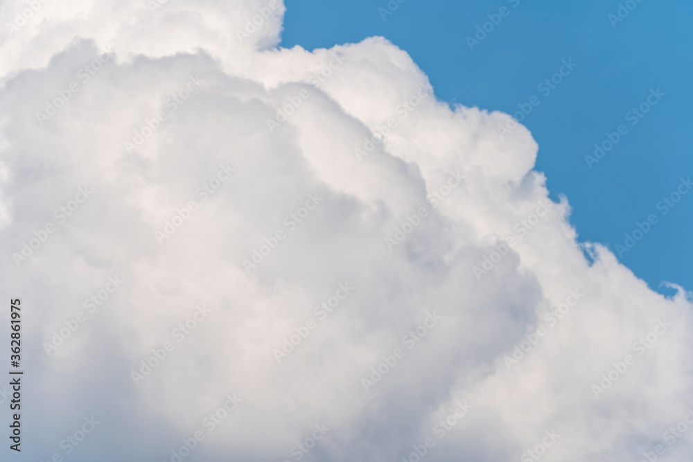 A large entrance cloud hovering in the blue sky in midsummer. A large entrance cloud hovering in the blue sky in midsummer.