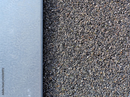 Tiny pebbles on waterproofing canvas and sheet of metal