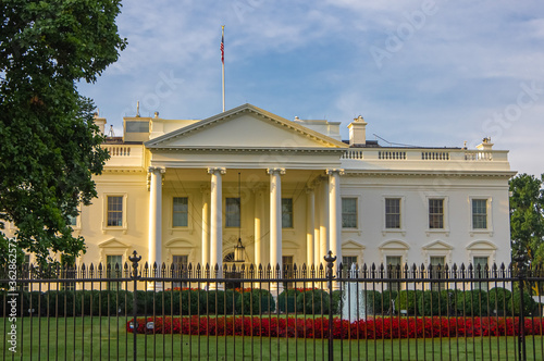 Sunrise light on the front entrance of White House, presidential residence and executive office of the President of the United States of America in Washington DC.