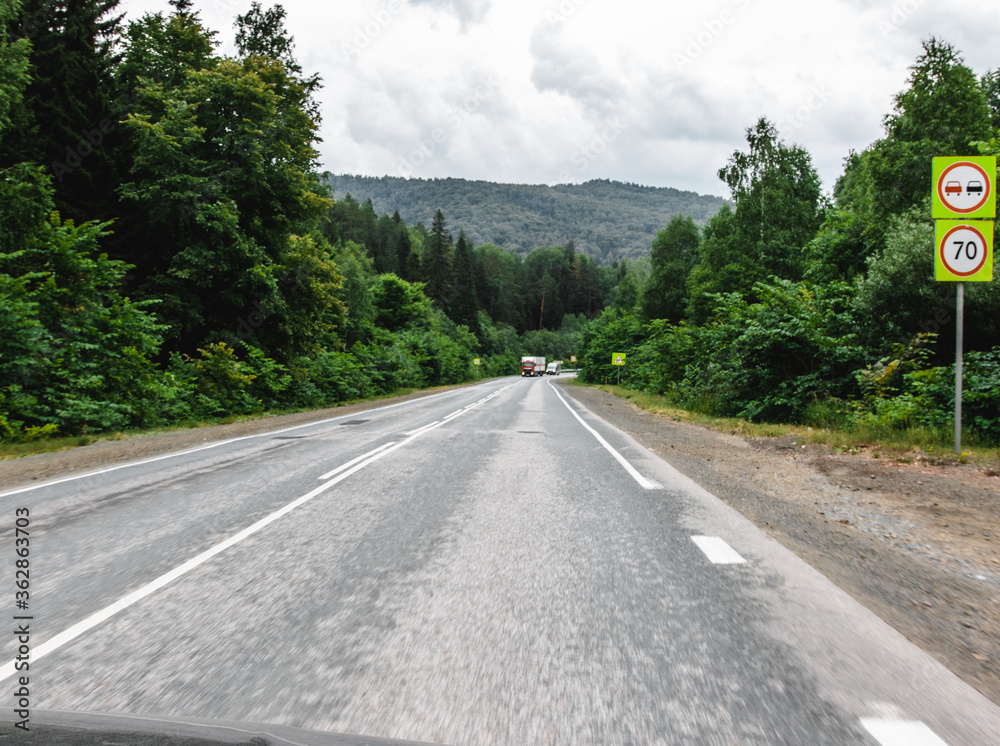 View from a moving car on a road View from a moving car on a road