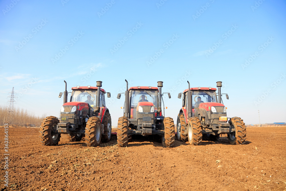 Rotocultivator in flat land in a farm, Luannan County, Hebei Province, Chinese Rotocultivator in flat land in a farm, Luannan County, Hebei Province, Chinese