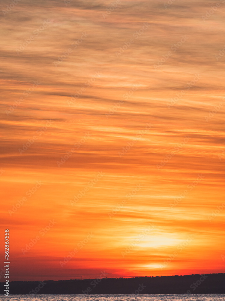 Abstract of red and golden sunrise and soft clouds