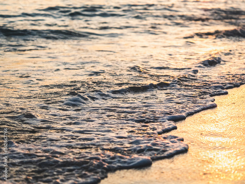 Close up abstract of ocean waves  coming in to shore at sunrise