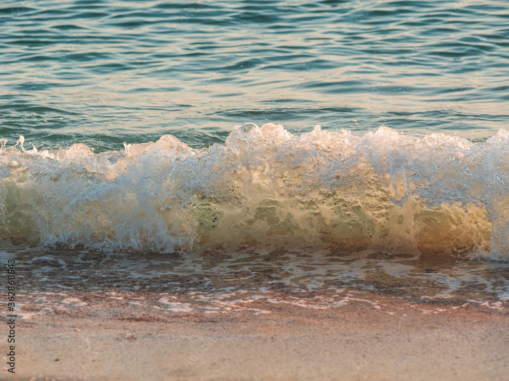 Close up abstract of ocean waves  coming in to shore at sunrise
