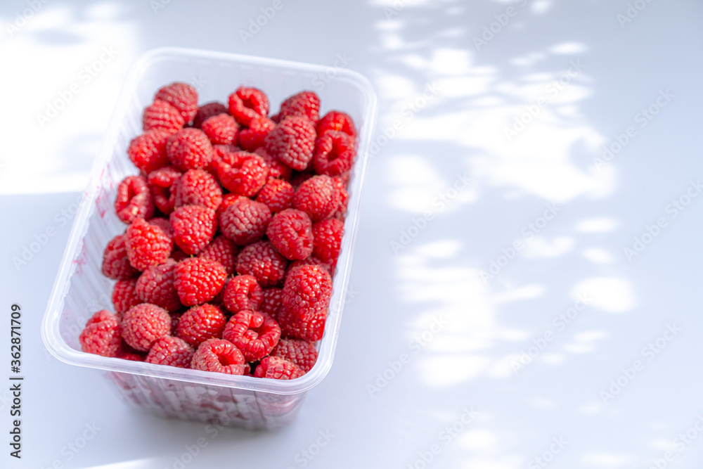 A container with fresh raspberries A container with fresh raspberries
