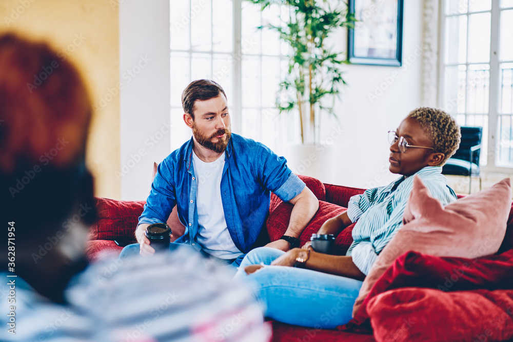 Multiracial woman and man talking to each other on coffee break in ...