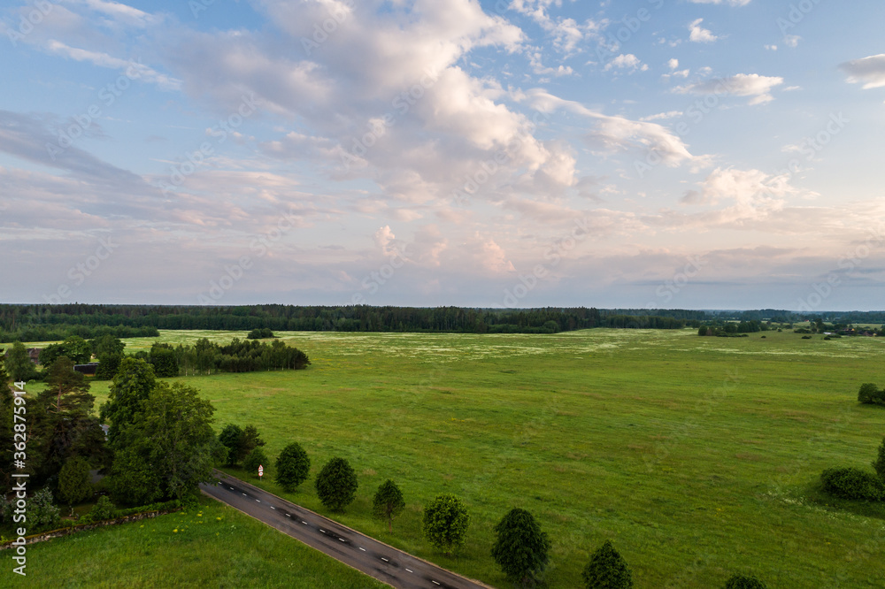 Aerial view of amazing sunset at summer season. Nature landscape. Landscape surrounded by green fields, rivers and trees. Aerial view of amazing sunset at summer season. Nature landscape. Landscape surrounded by green fields, rivers and trees.