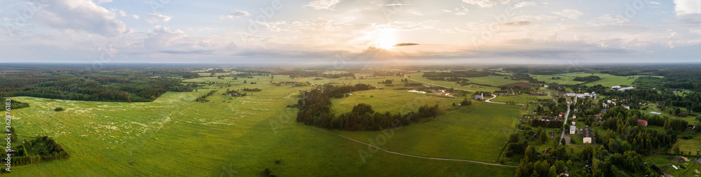 Aerial view of amazing sunset at summer season. Nature landscape. Landscape surrounded by green fields, rivers and trees.