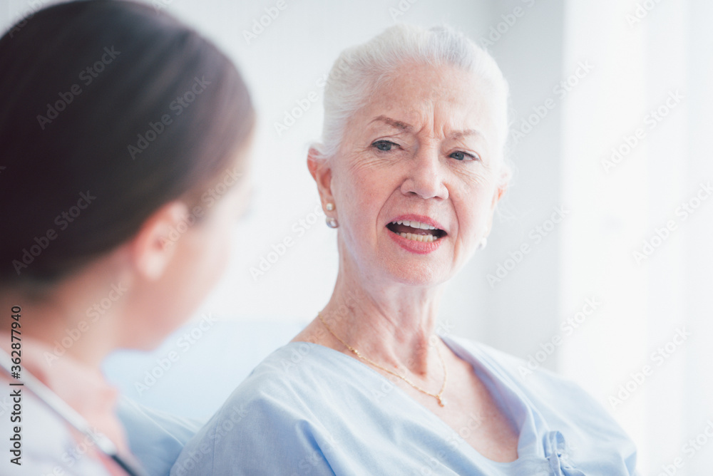 Happy Elderly patient talk with woman doctor at room in hospital. Healthcare homecare concept Happy Elderly patient talk with woman doctor at room in hospital. Healthcare homecare concept