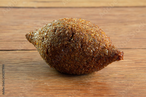 Kibbeh. Brazilian snack on the wooden table. Isolated. photo