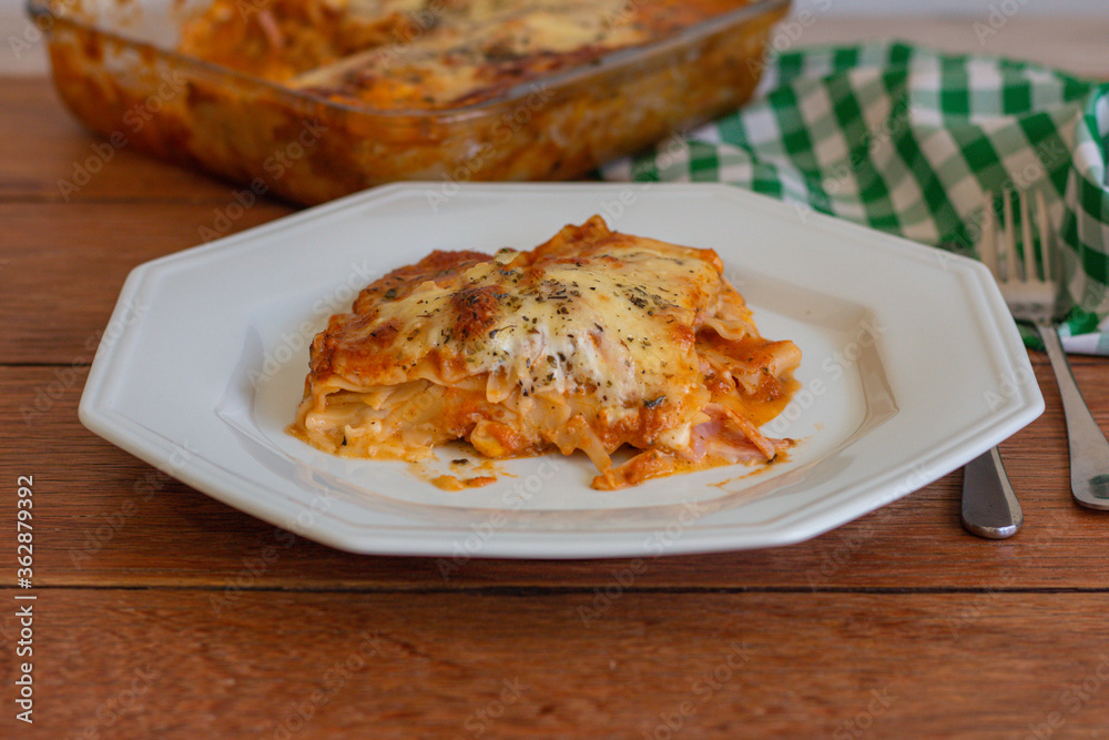Traditional italian lasagna with cheese. On a wooden background.
