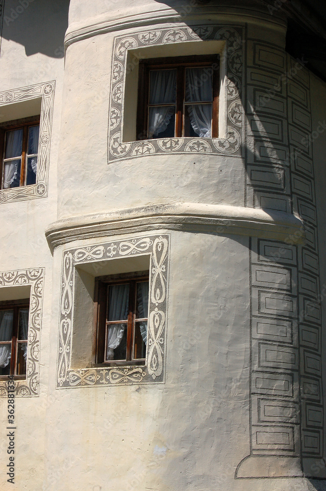 Traditional windows of a white house with frescoed decorations, Engadin valley, Graubunden canton, Switzerland, Europe