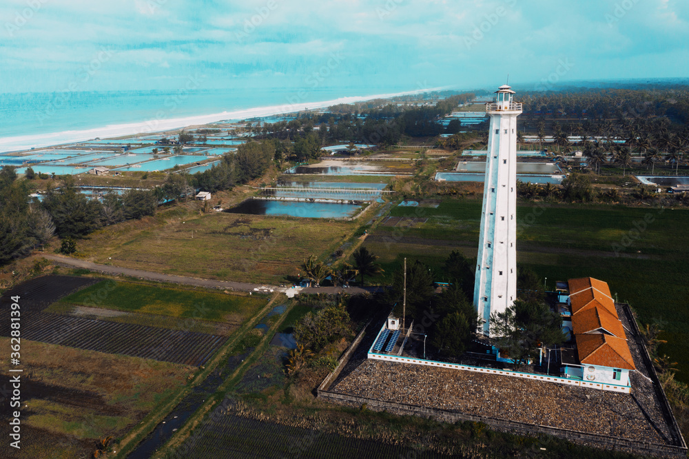 Aerial view Ketawang beach with white lighthouse. Historic lighthouse in Purworejo