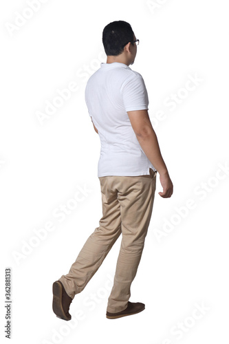 Full length portrait of Asian man wearing white shirt and khaki jeans standing walking, rear view