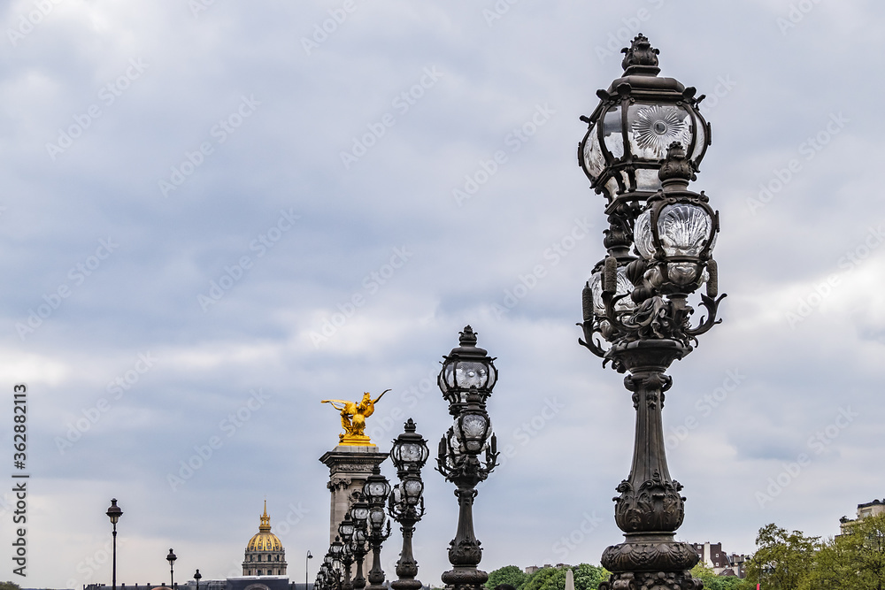 Art Nouveau lamps on famous Alexandre III Bridge in Paris. Alexandre III Bridge, with exuberant, cherubs, nymphs and winged horses at either end, was built in 1896 - 1900. Paris, France.