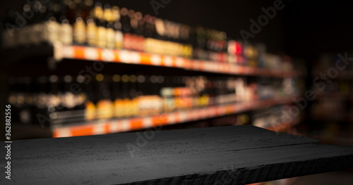 Beer style- bottle, beer in the glass and covers on wooden table. Free space for text. Top view