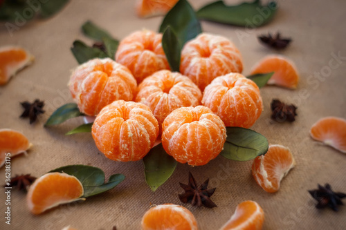 Delicious and beautiful Tangerines. Peeled Tangerine orange and Tangerine orange slices on a Dark Background. Citrus background, Top view.