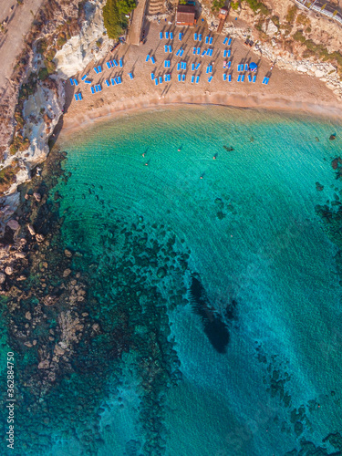 Amazing aerial view over one of the best beaches in Protaras, Cyprus. Yellow sand, blue and turquoise water - perfect summer getaway, luxury vacation in Mediterranean 